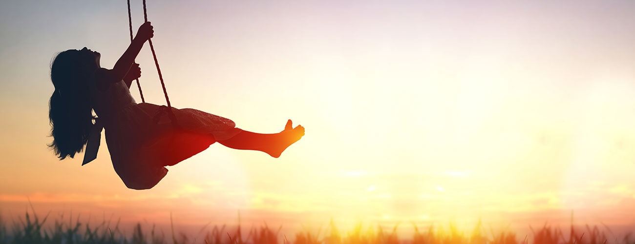 Girl on a swing, sun is setting